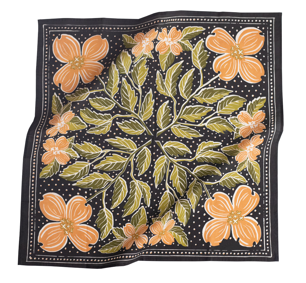Square black scarf with orange dogwood-style flowers and green leaves in radial pattern and white polka-dot background.