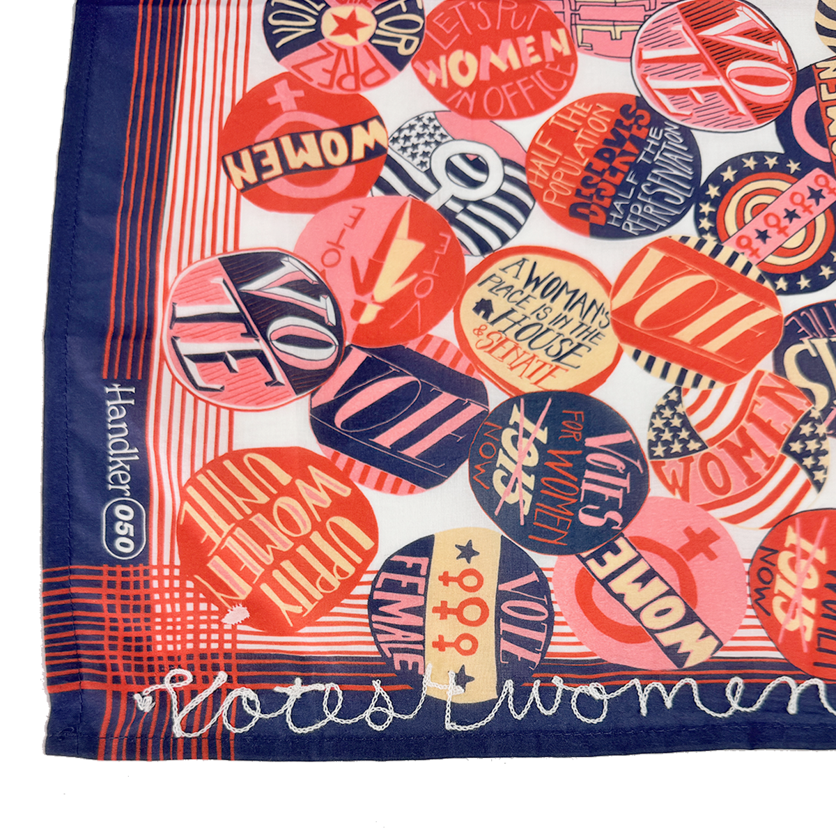 Patterned scarf with circular suffrage buttons; visible text: 'Votes for Women', 'VOTE', 'WOMEN'.