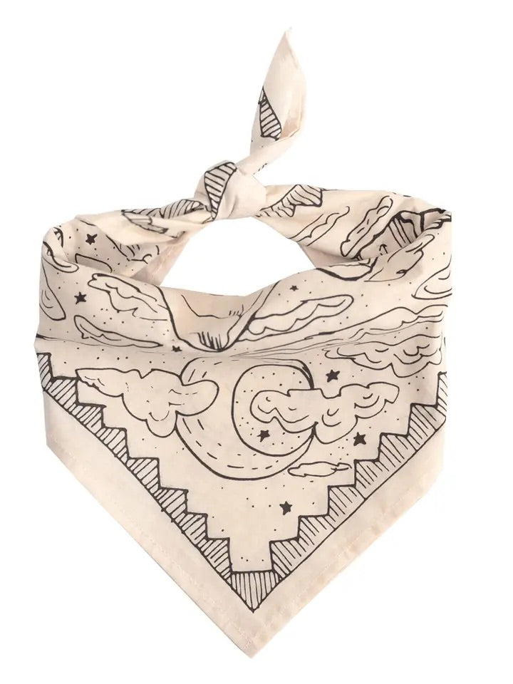 Folded No. 068 Desert bandana showing cream cotton with black moon, clouds, stars and stepped border on white background