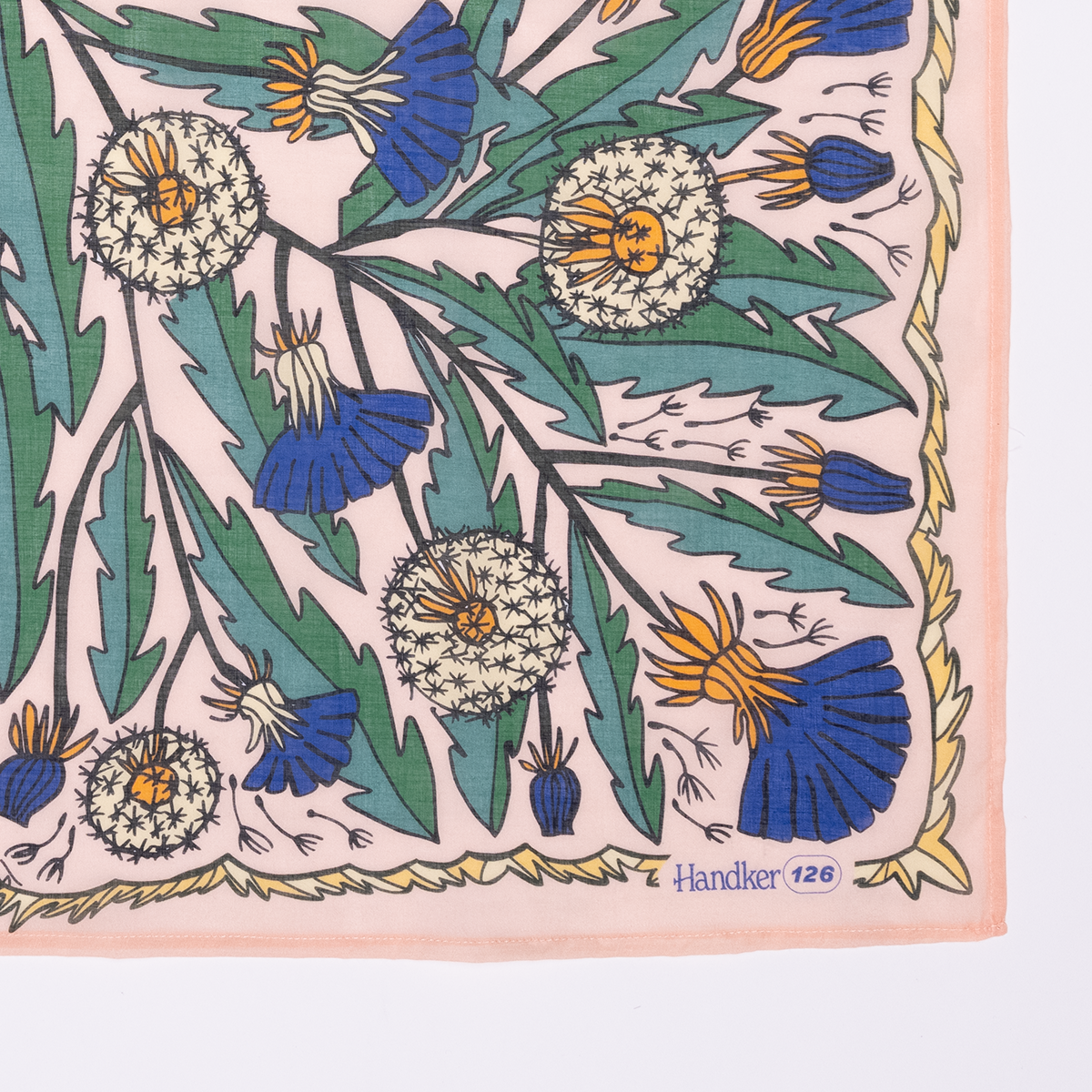 Floral patterned fabric with dandelions and blue flowers.