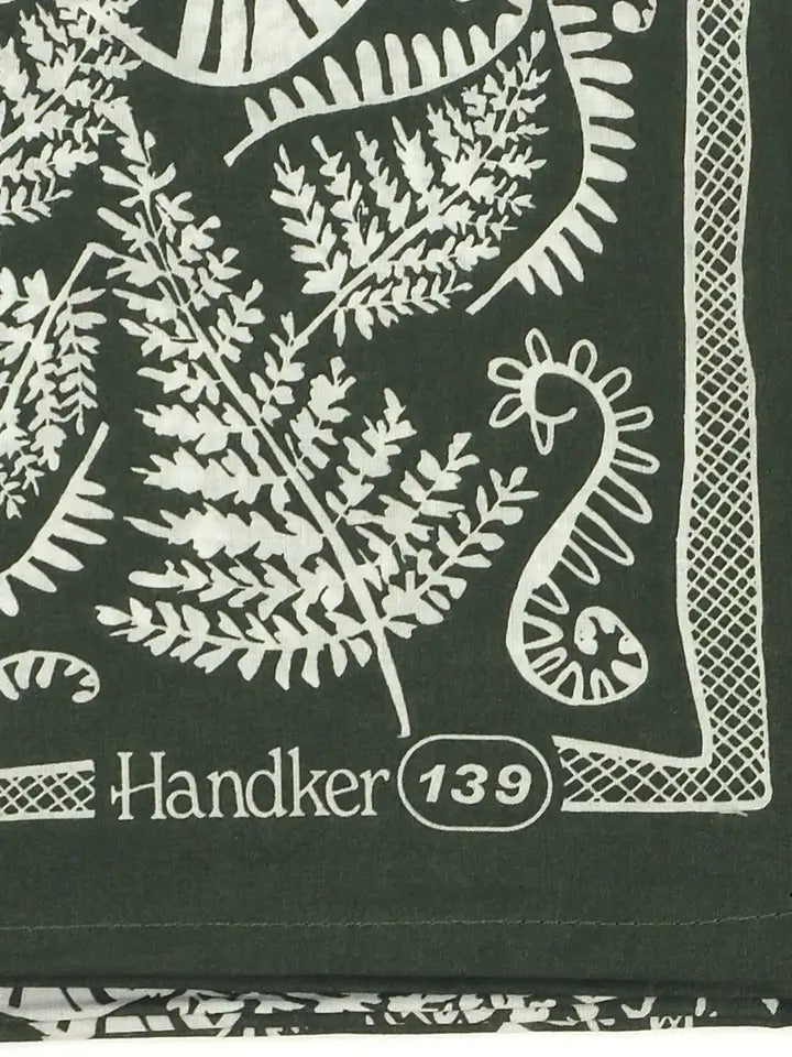 Close-up of No. 139 Fern bandana showing white fern print and hand-printed 'Handker 139' corner on dark forest green cotton