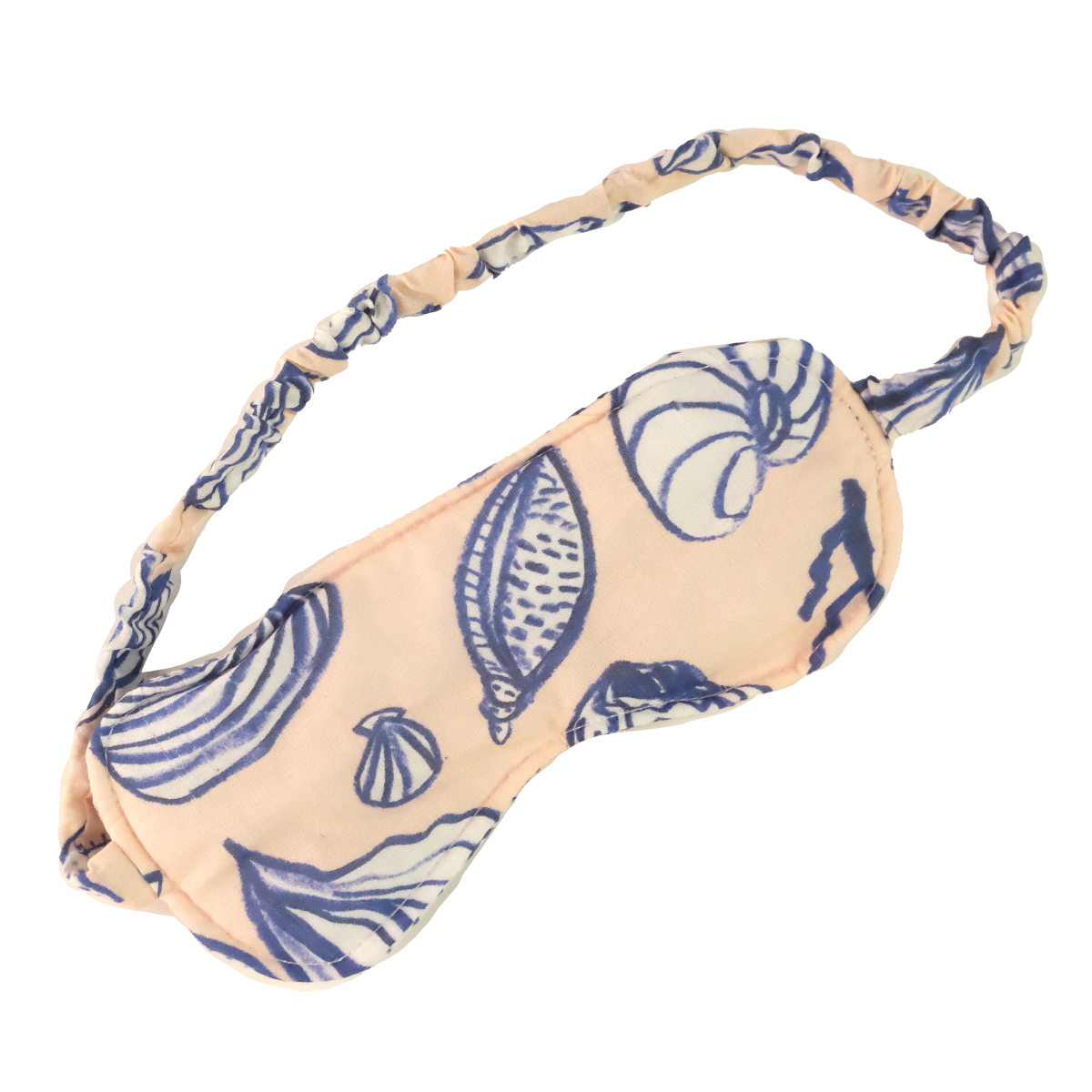 Peach fabric sleep mask with blue seashell print and elastic ruched strap