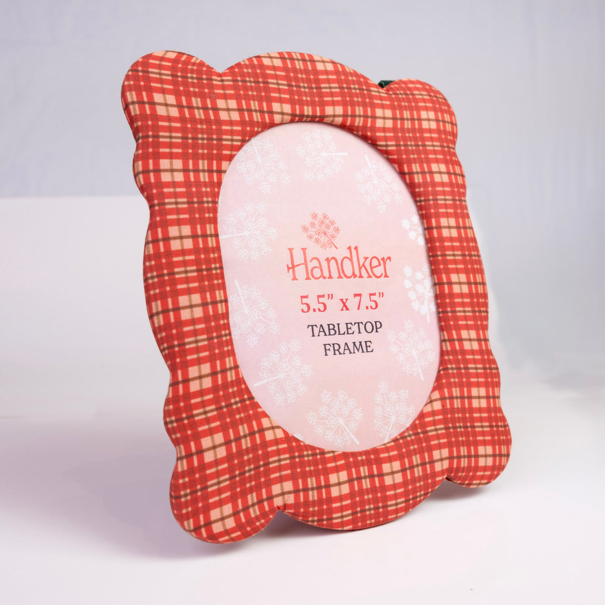 Angled front of Marley 8x10 fabric tabletop frame, red and cream plaid scalloped edge, 5.5”x7.5” oval opening