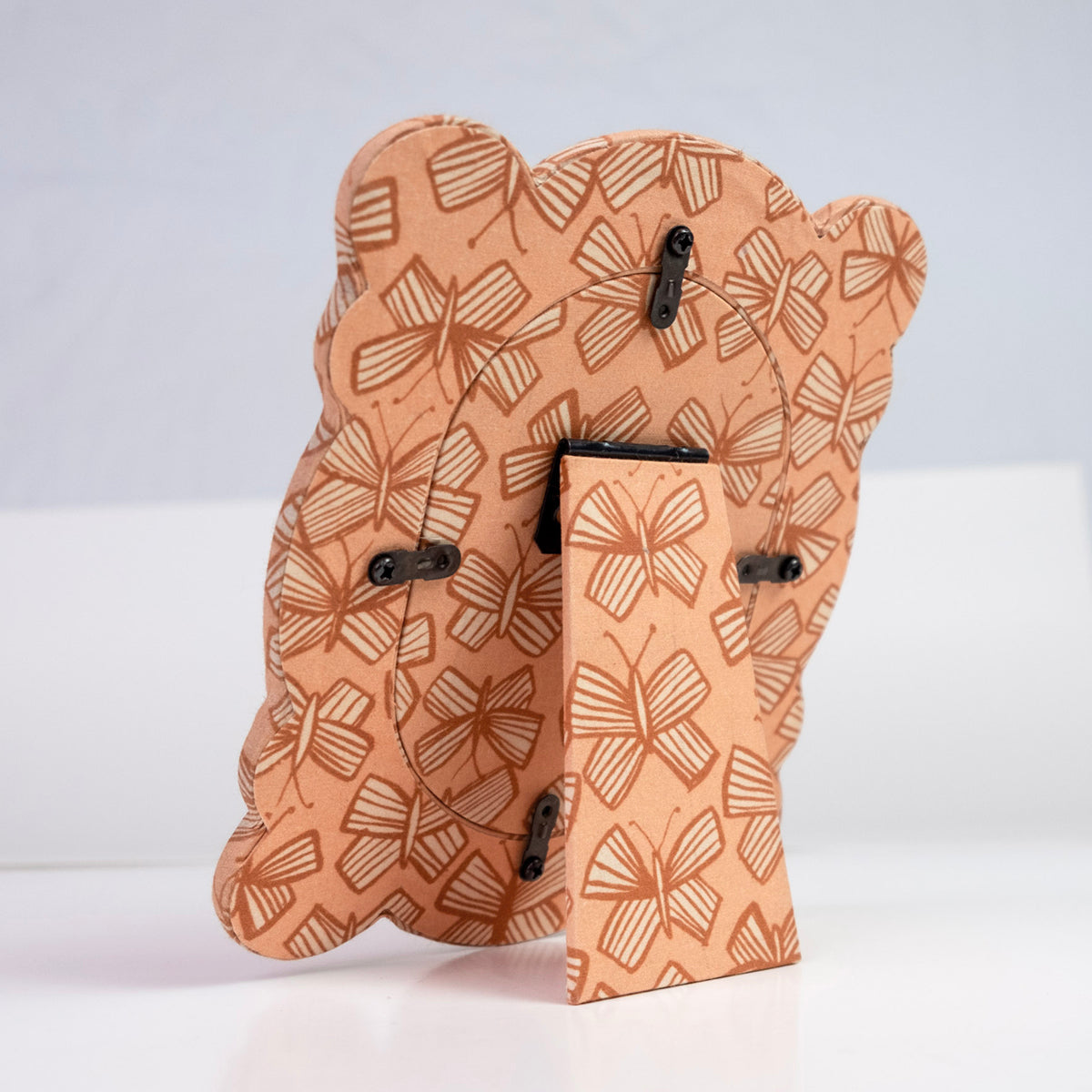 Rear view of Sally 6x7 fabric desktop frame showing padded fabric cover with peach pink butterflies and easel stand