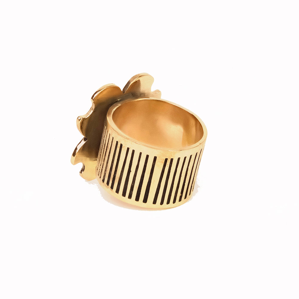 Gold open-band ring with vertical ribbed band and small flower accent