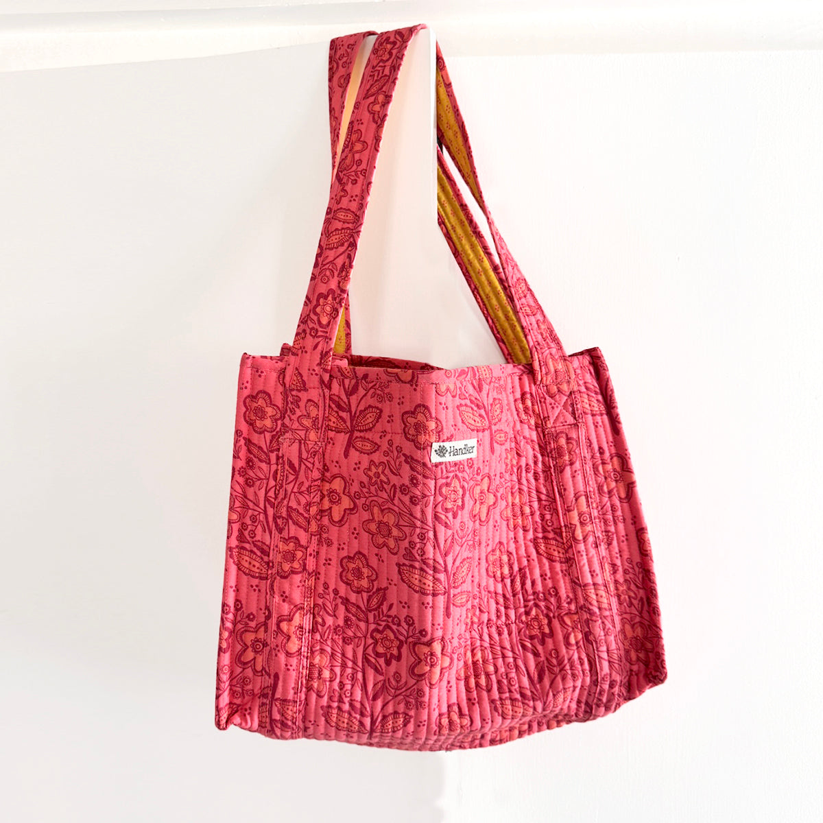Red floral patterned tote bag with 'Handker' logo