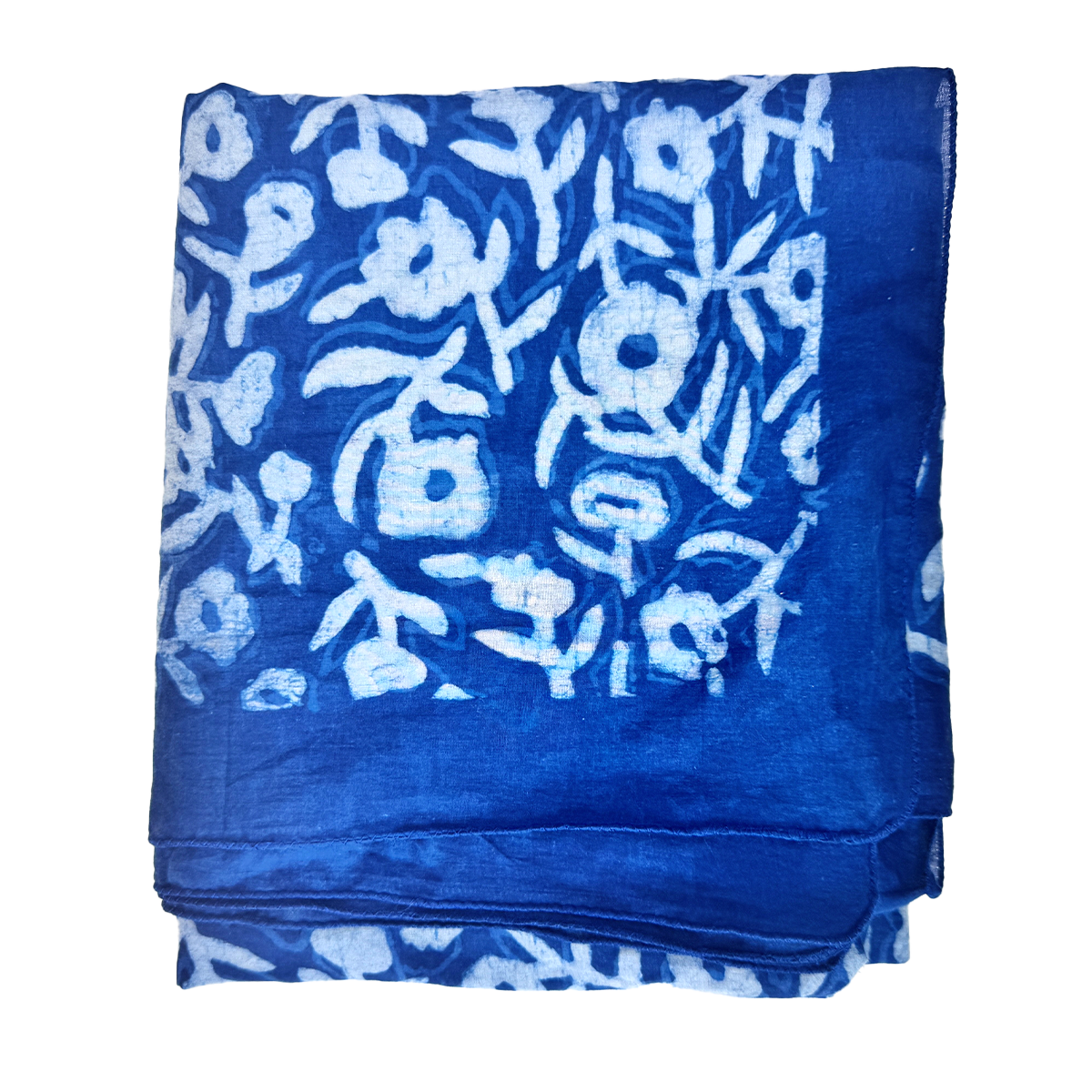 Folded Neela indigo-dyed cotton scarf showing white Dabu mud-resist floral print and deep indigo border