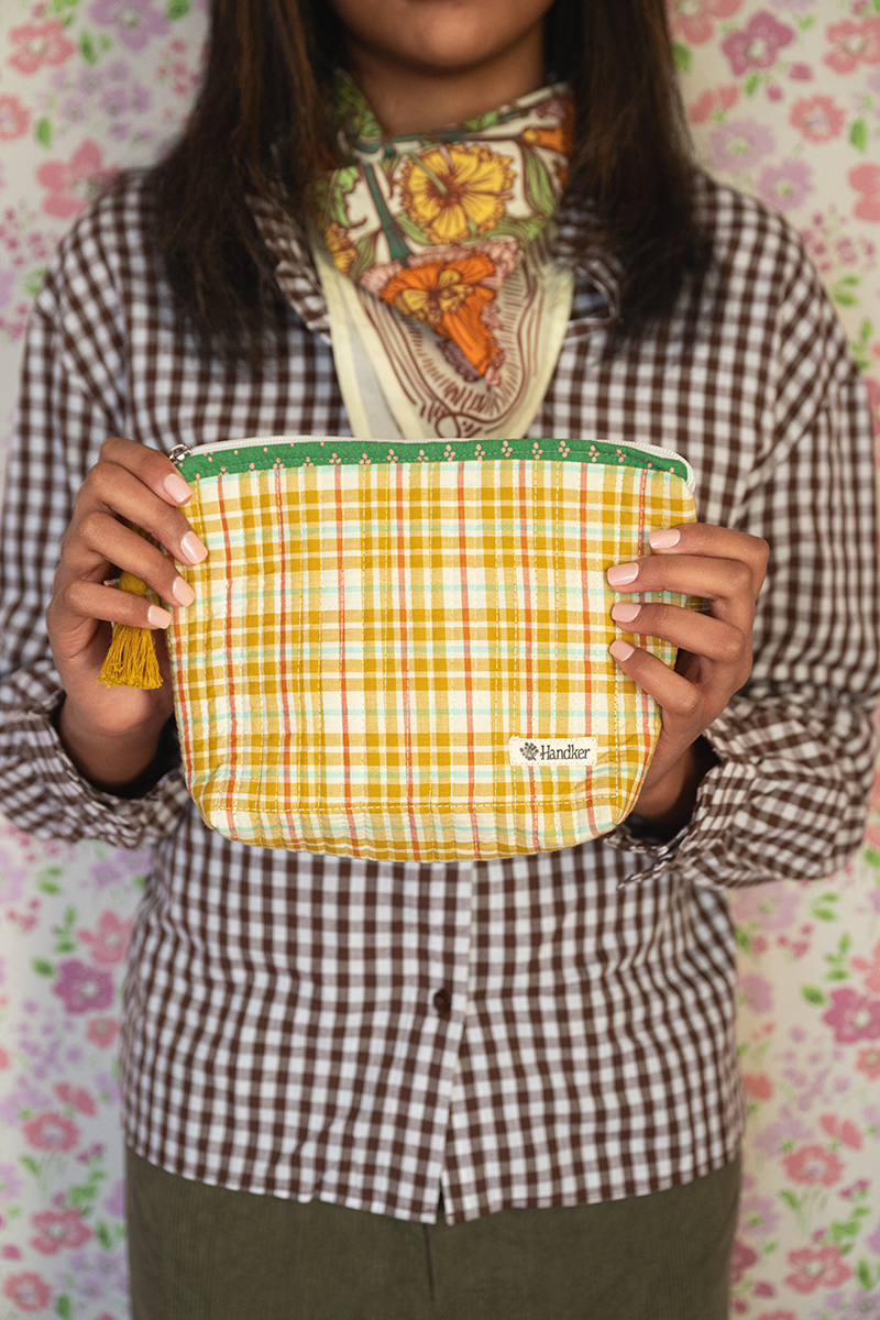 Front view of Josephine Quilted Tote in green floral quilted cotton with wide shoulder straps and yellow plaid scarf tied to handle
