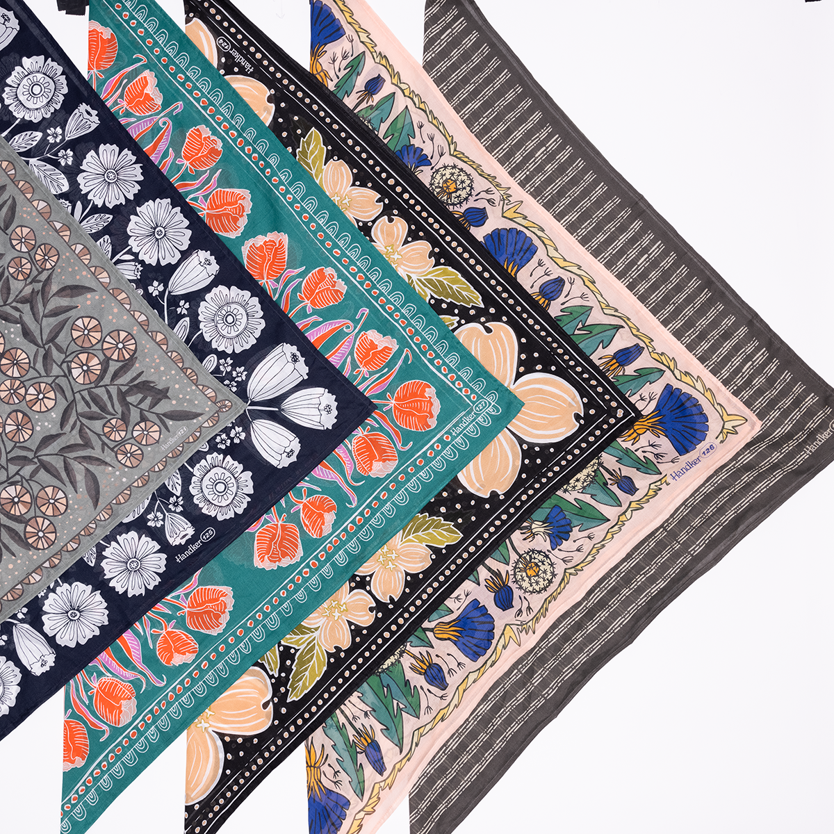 Stacked Handker bandanas with floral, tulip and striped patterns in teal, navy, peach and gray