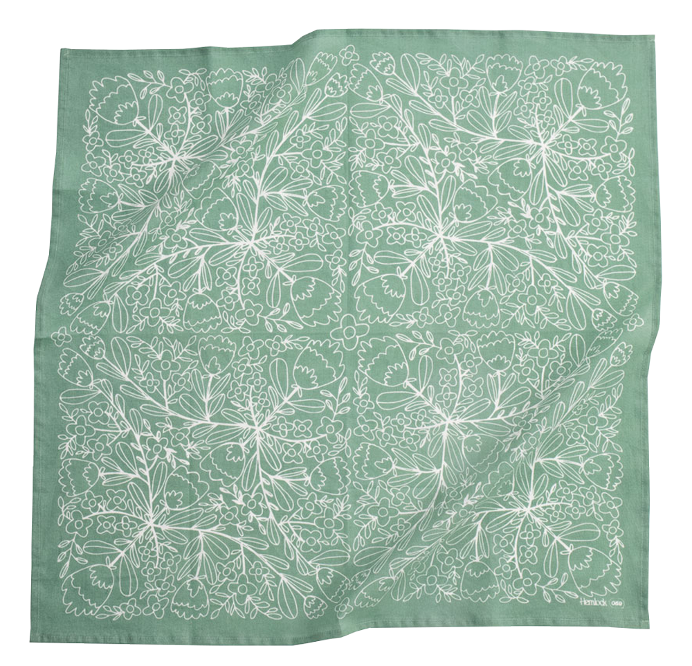 Green square scarf with intricate white floral pattern