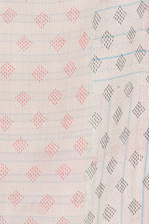 Patterned textile with red and blue geometric designs.