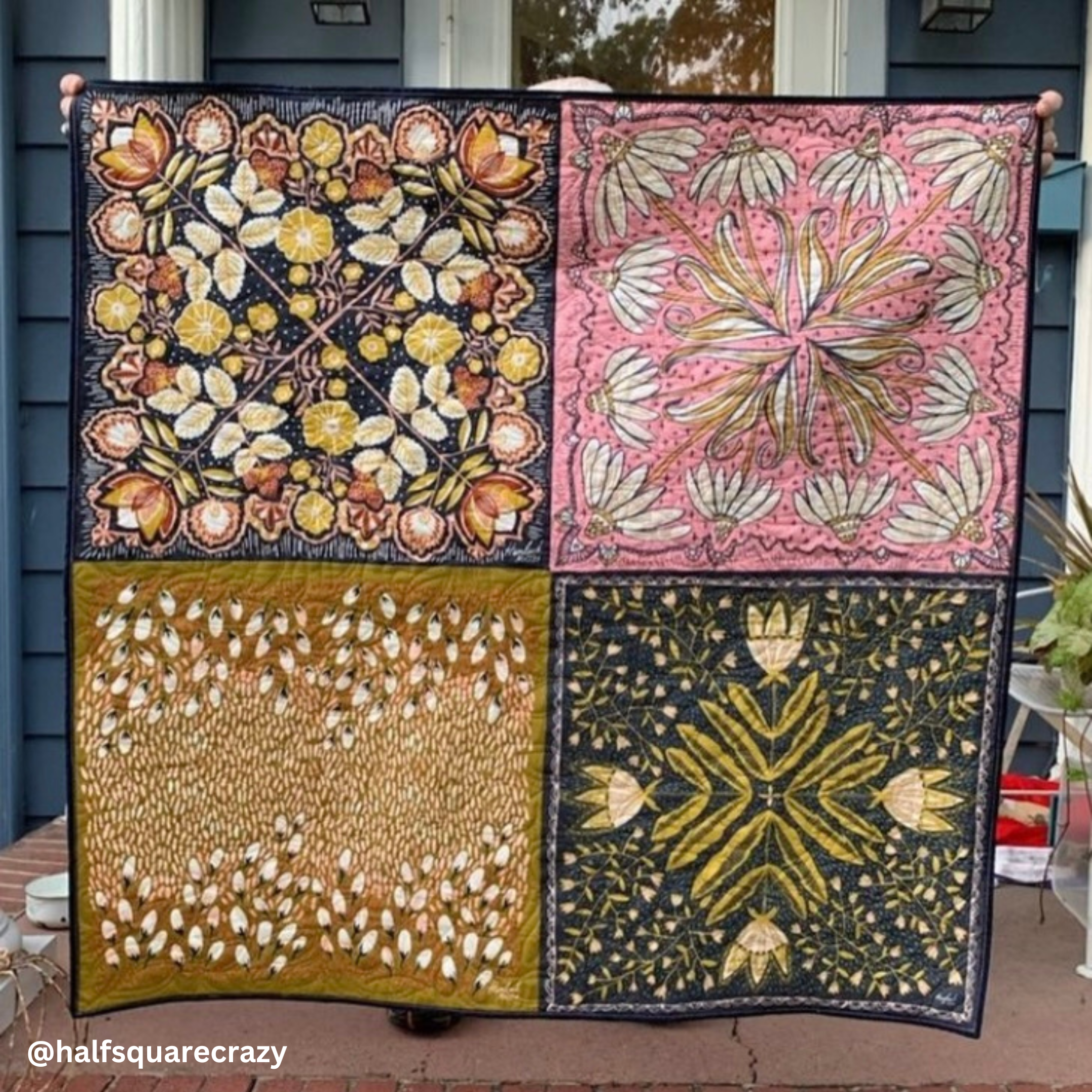 Handmade quilt of four bandana panels with floral and geometric prints in pink, mustard, olive, and navy