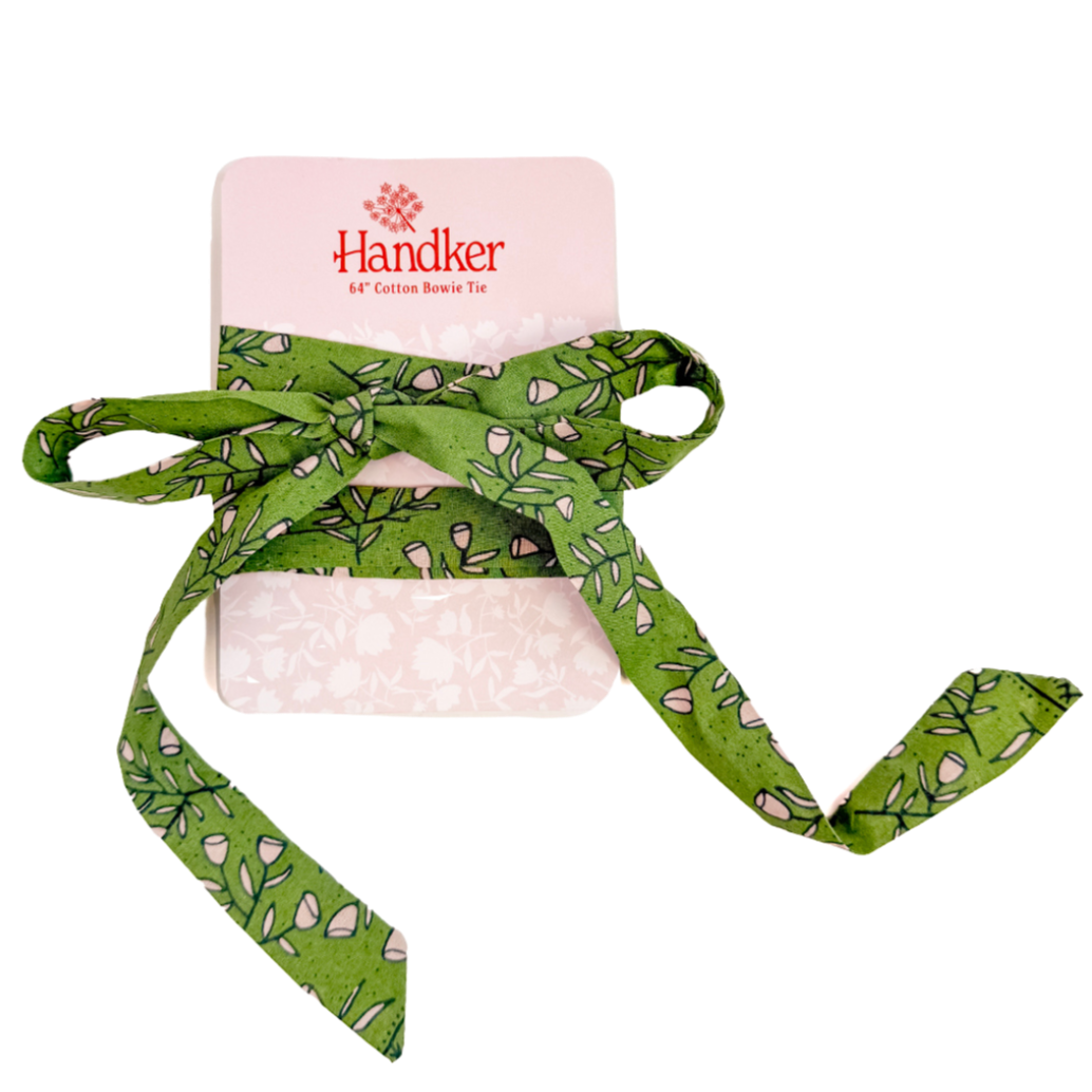 Green floral-print cotton bow tie tied on pink card labeled Handker 64" Cotton Bowie Tie.