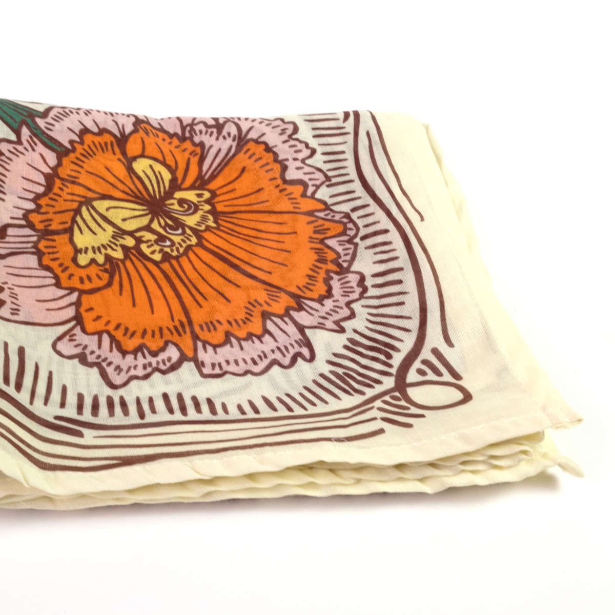 A folded cream-colored cotton bandana or napkin featuring a vintage-style orange and pink floral print with brown linework, set against a plain white background.