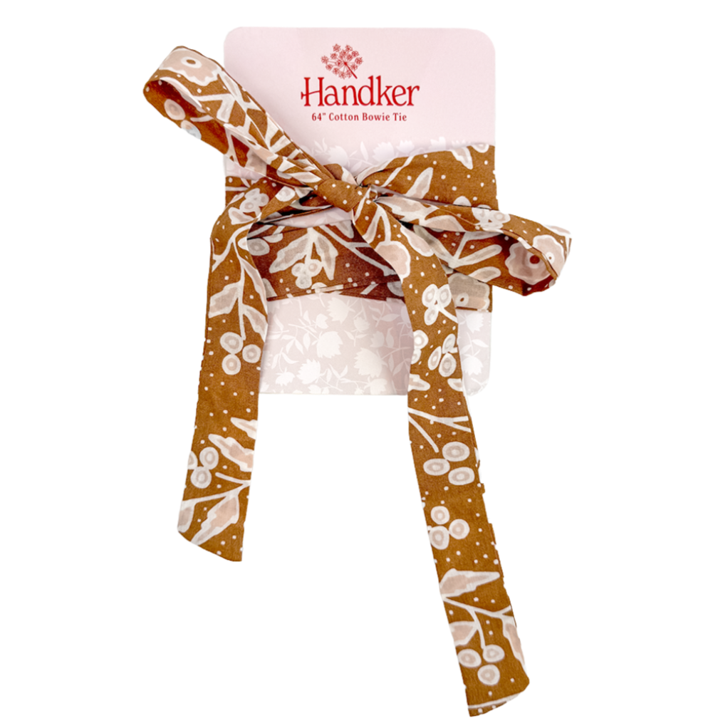 Brown cotton bow tie with white floral print tied on pale pink card labeled 'Handker 64" Cotton Bowie Tie'