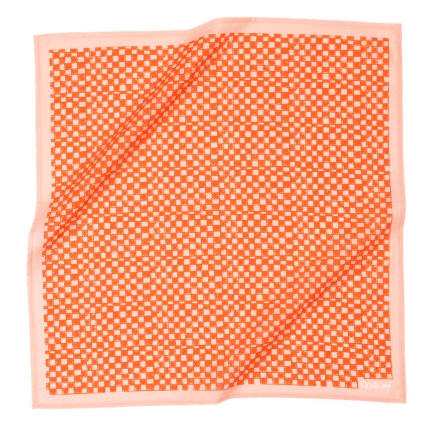 Orange and white checkered fabric square with a light pink border