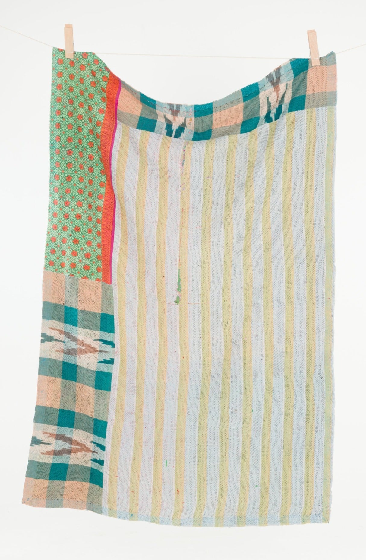 Colorful striped and patterned fabric hanging on a clothesline