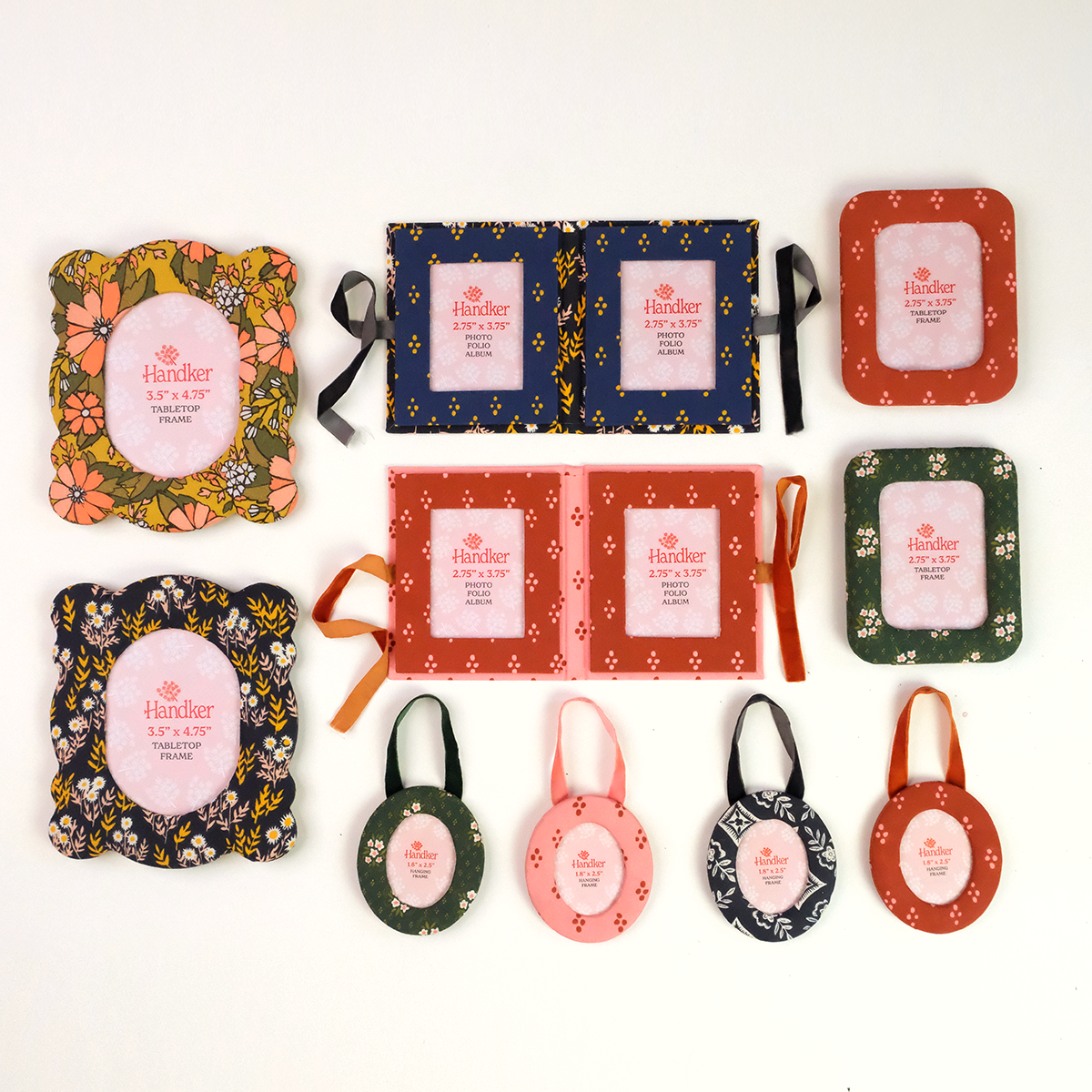Assorted floral-packaged rectangular soaps and round hanging tags arranged in rows on a white background.