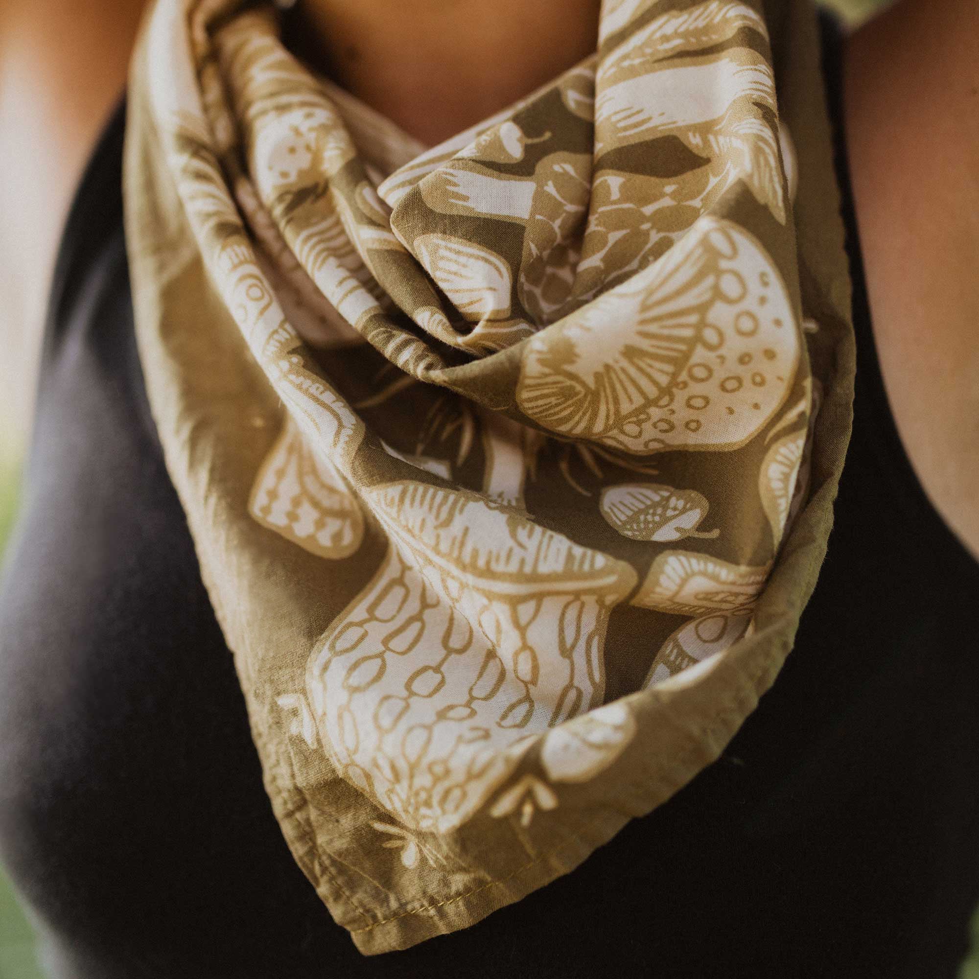 Person wearing a mushroom-patterned scarf
