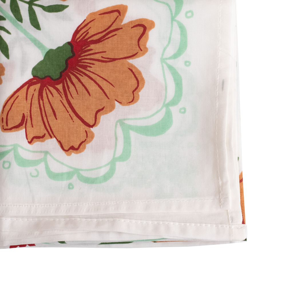 Close-up of a white fabric with orange floral design.