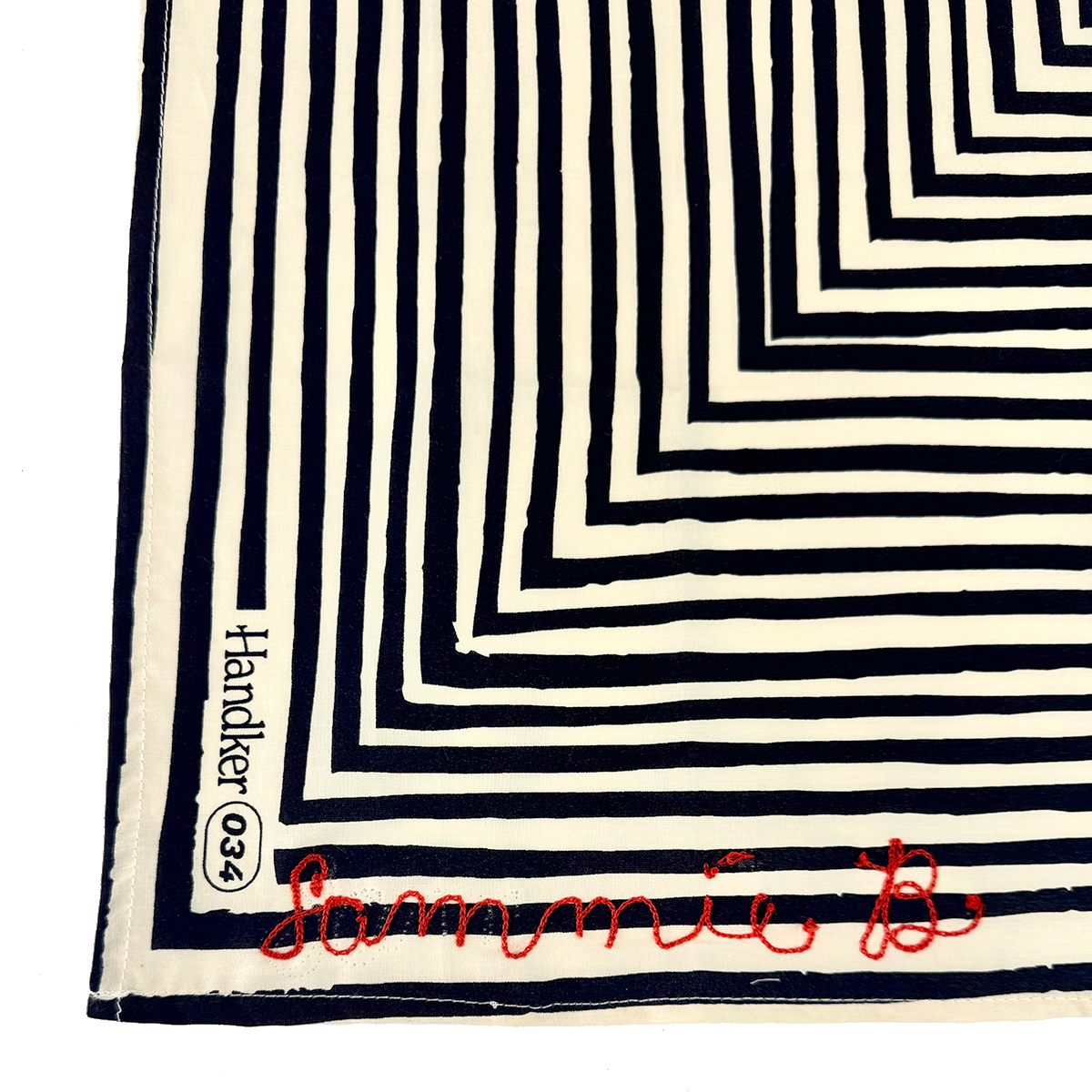 Black-and-white striped square scarf with 'habitat co.' on the left edge and red cursive signature 'Sammie B'.