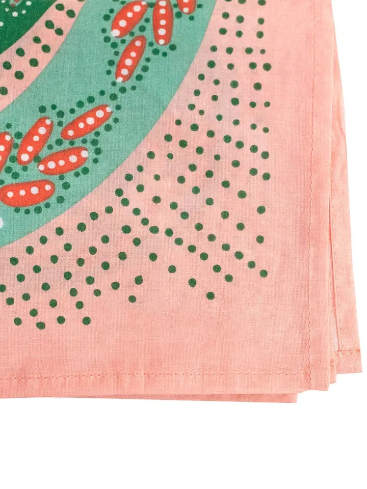 Close-up corner of No. 069 Snakes pink bandana showing green and red snake print and stitched hem on white