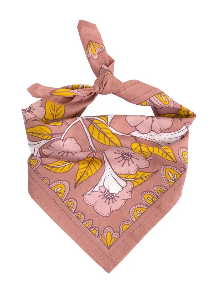 Folded front view of Evangeline bandana showcasing dusty pink floral print with mustard leaves and white accents on a white background