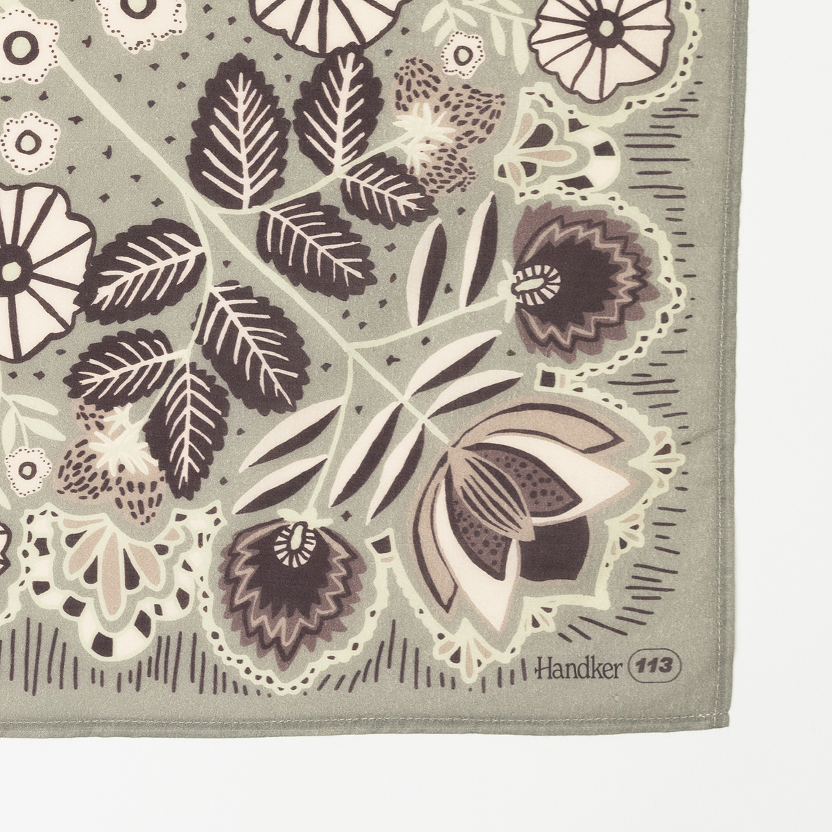 Floral green-and-pink bandana corner with stitched hem and printed 'Handker 113'