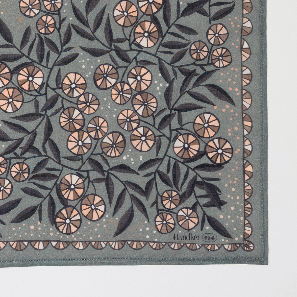 Flat lay of Eleanor bandana corner showing floral print on warm gray background with cream and mauve accents