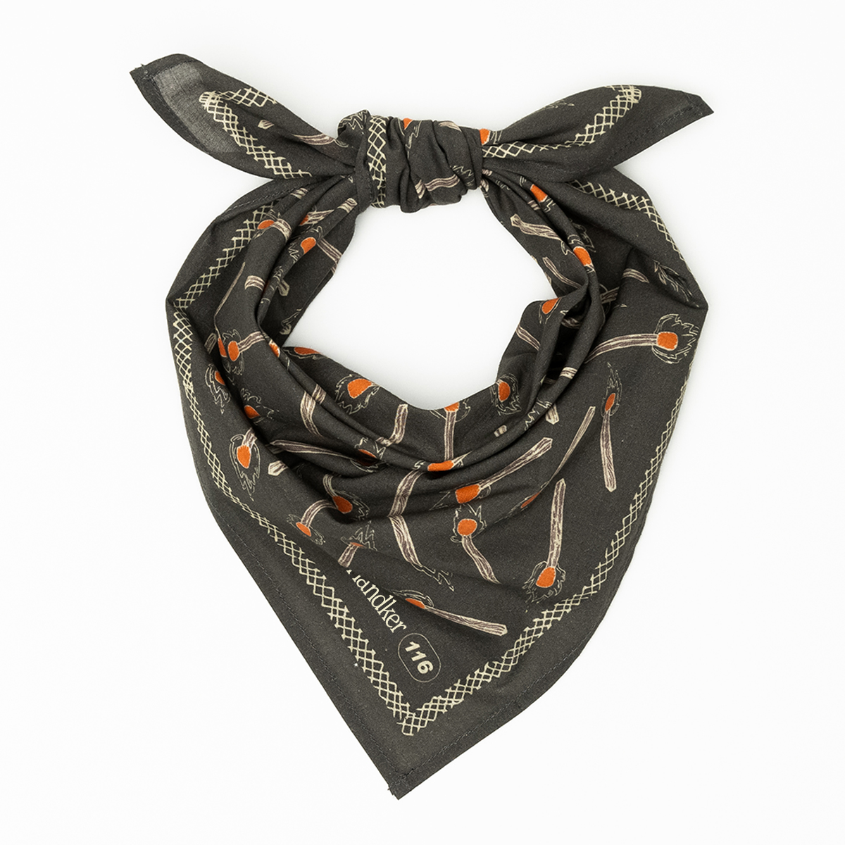 Flat lay of No. 116 Edith bandana showing charcoal fabric with orange-tipped matchstick print on white background