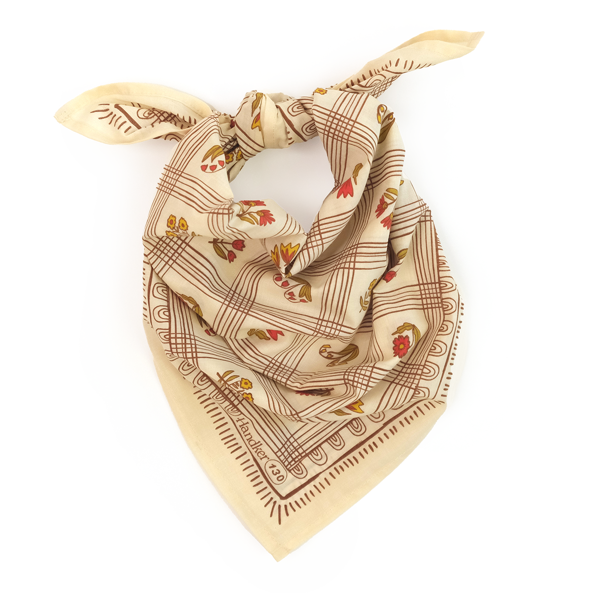 Cream silk scarf knotted with a brown geometric border and small red fruit motifs.