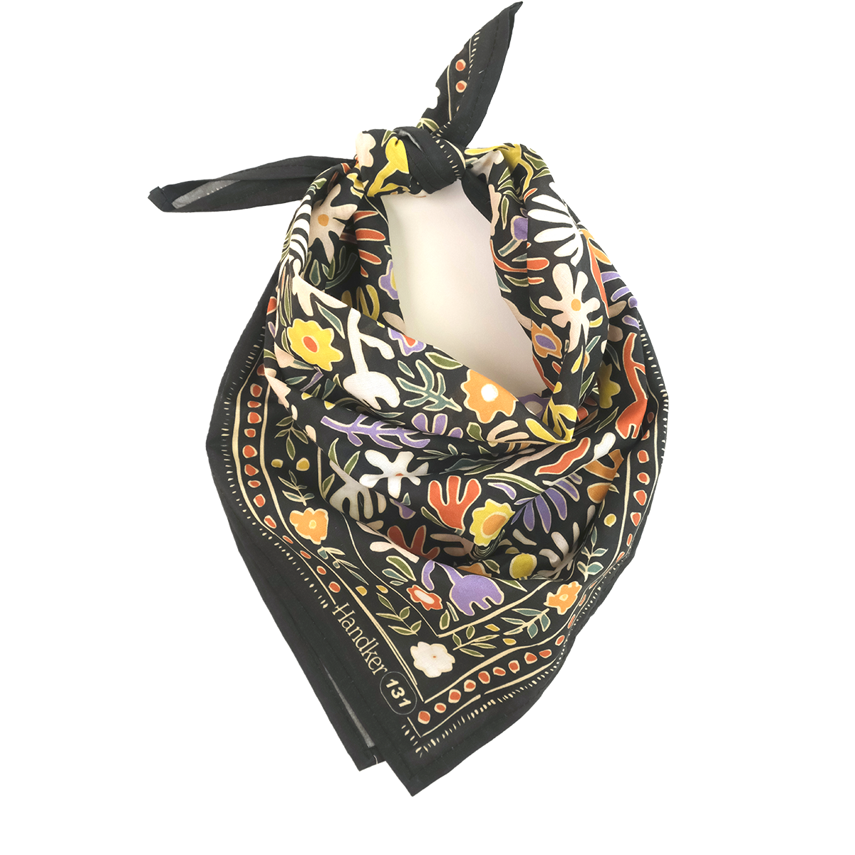 Front view of No. 131 Henri bandana tied in a triangular drape, showcasing colorful floral print on a black background