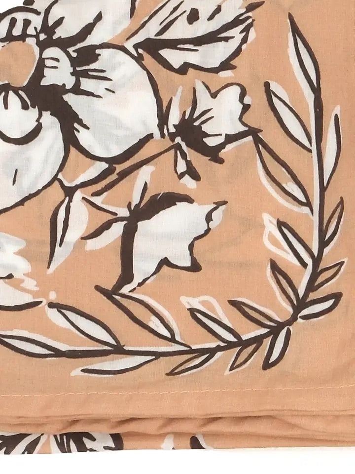 Close-up of No. 135 Georgia bandana showcasing white floral print with chocolate brown outlines on a soft peach background