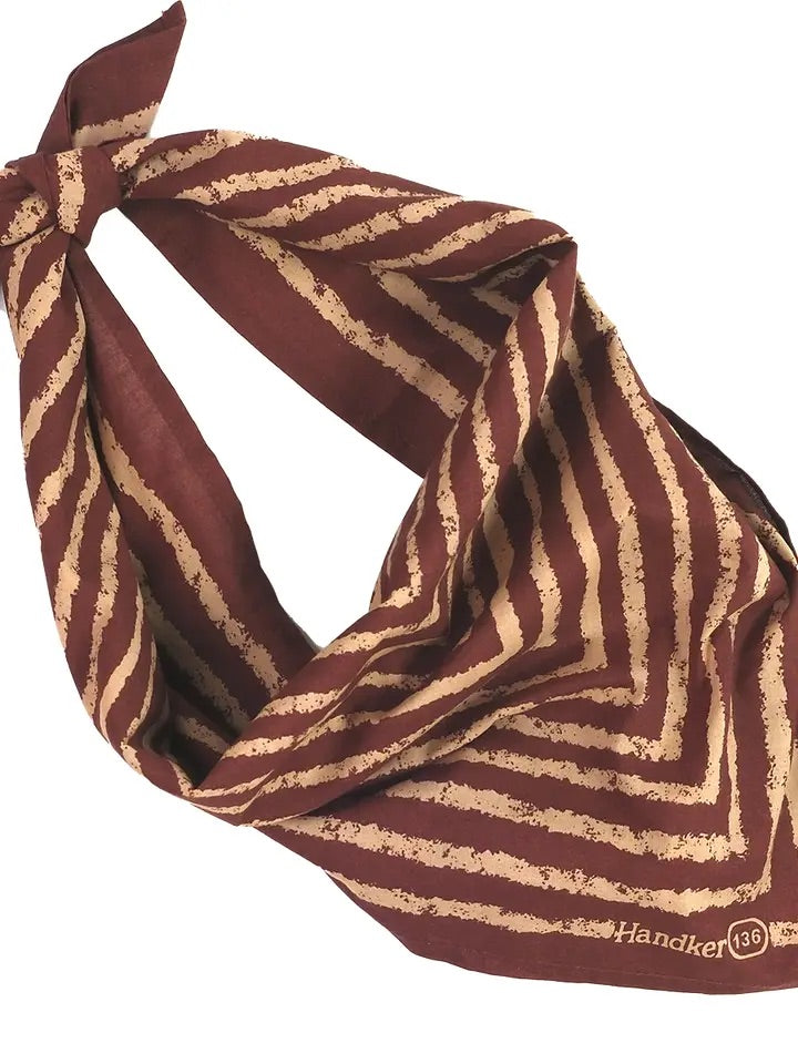 Top-down view of Sammie pink stripe bandana showcasing tan hand-printed diagonal stripes on pink background with white backdrop