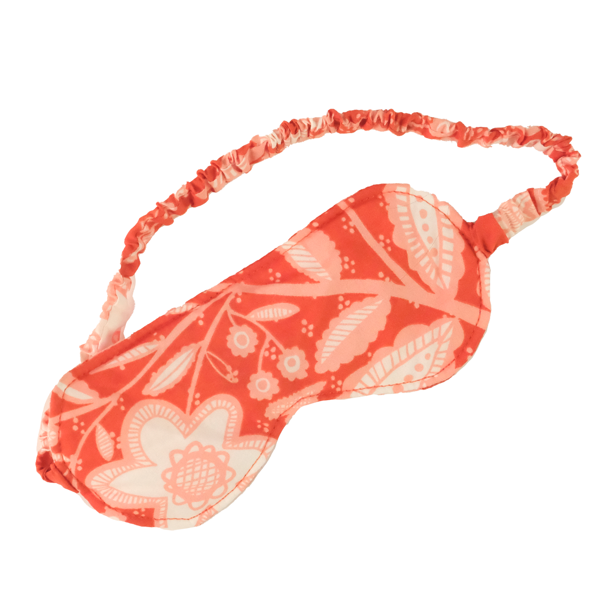 Coral and white floral-patterned fabric sleep mask with gathered elastic strap