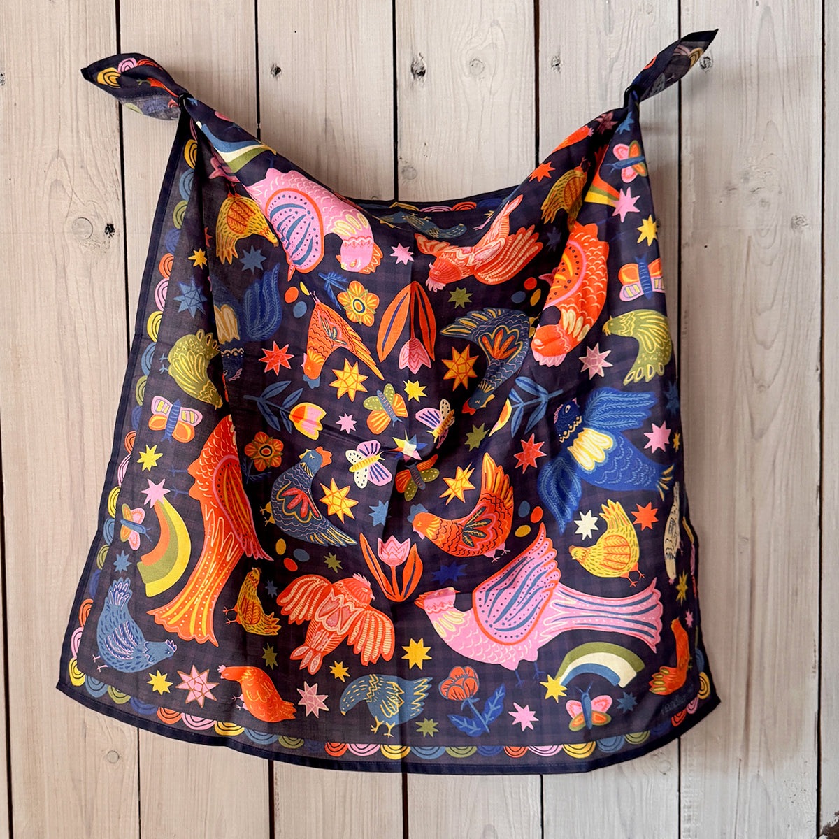 Colorful patterned bandana draped over a wooden surface