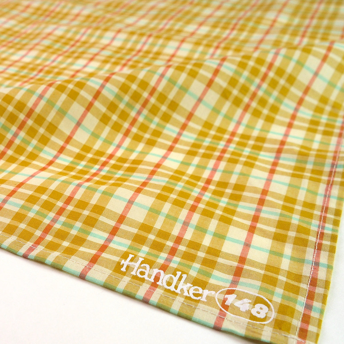 Plaid fabric with 'Handker 148' logo on a white background
