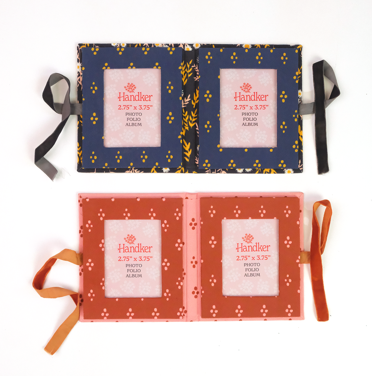 Two ribbon-tied fabric photo frames, navy with yellow pattern and coral with white motif; each has two square openings.