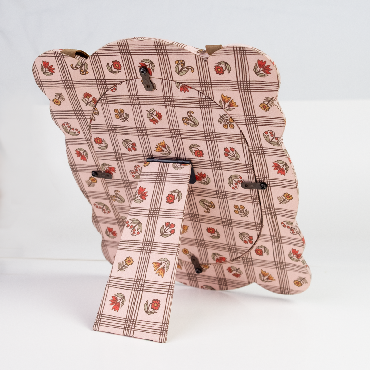 Rear view of Laura Pink 8x10 fabric frame showing padded pink floral-plaid cover, easel stand and hanging ribbon