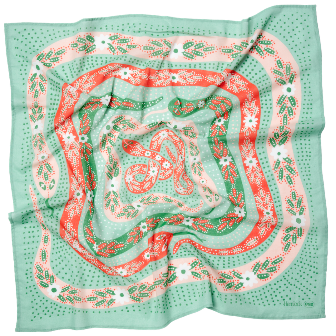 Square silk scarf with green, pink and red floral bandana pattern and folds; label reads Hemlock 092.