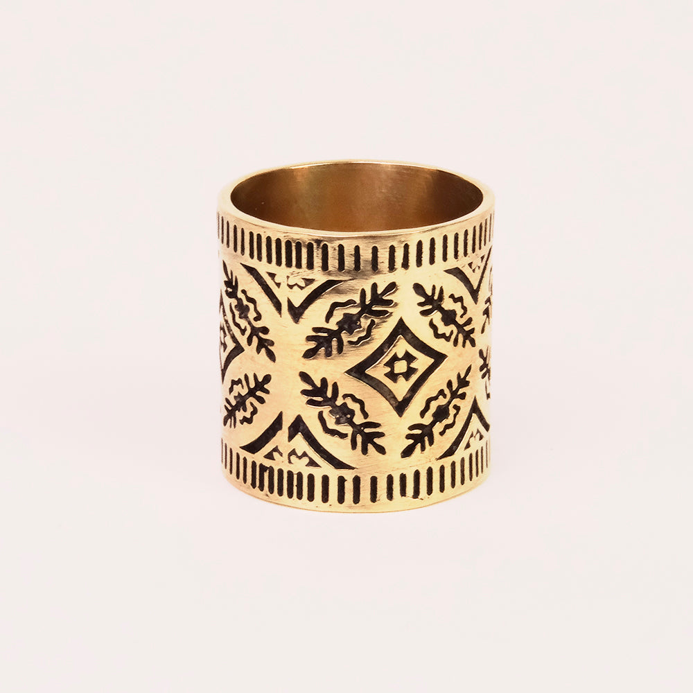 Brass ring with intricate engraved patterns