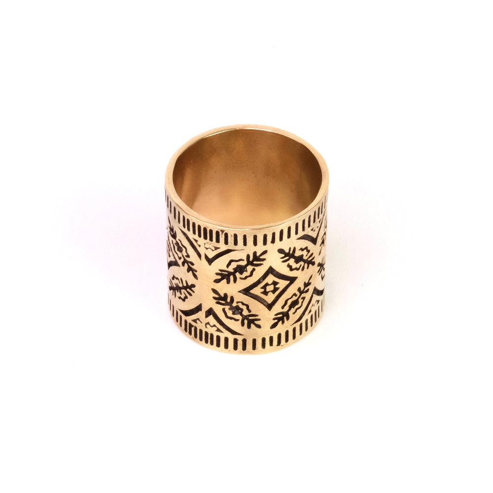 Gold ring with intricate engraved patterns