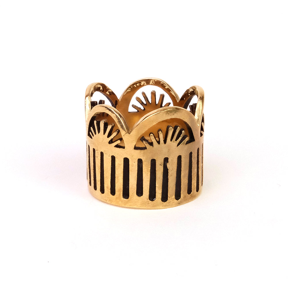 Gold decorative ring with sunburst pattern