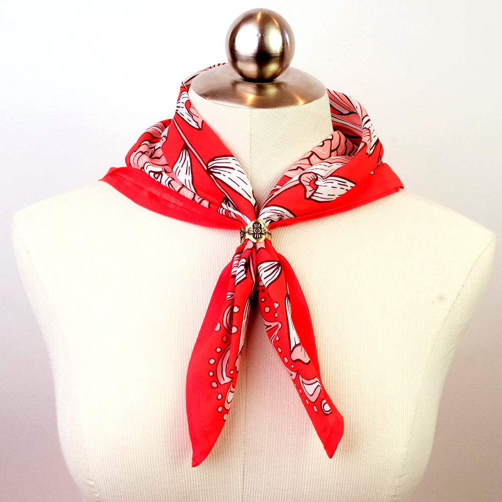 Red patterned scarf tied on a mannequin bust