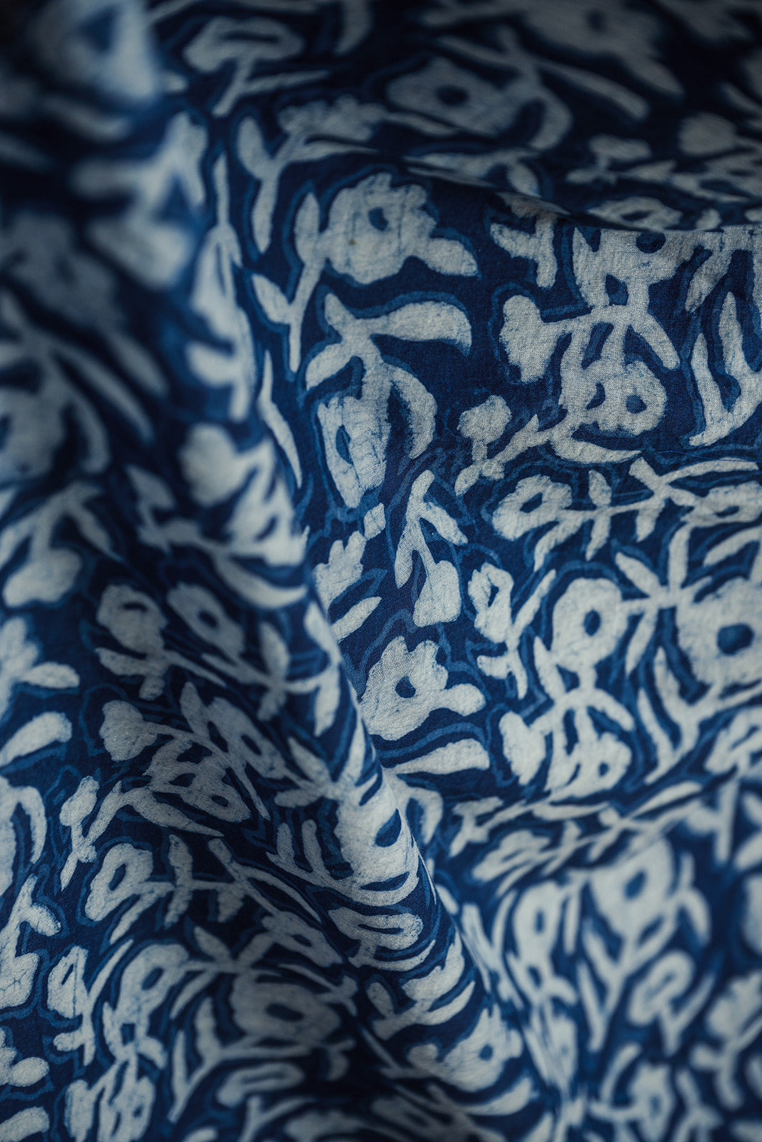 Close-up of Neela indigo-dyed cotton scarf showcasing white Dabu mud-resist print and gauzy drape