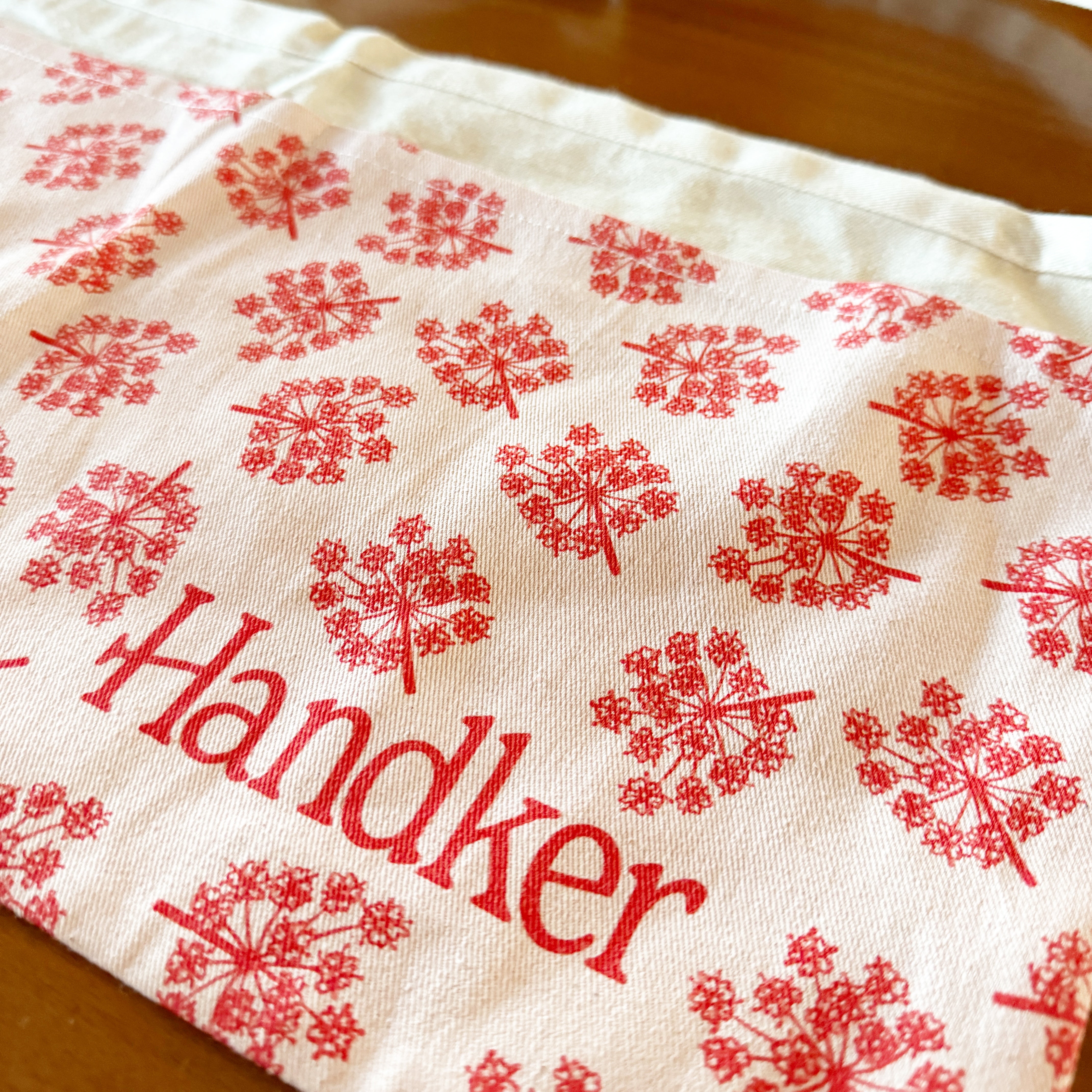 Red and white patterned fabric with "Handker" text.