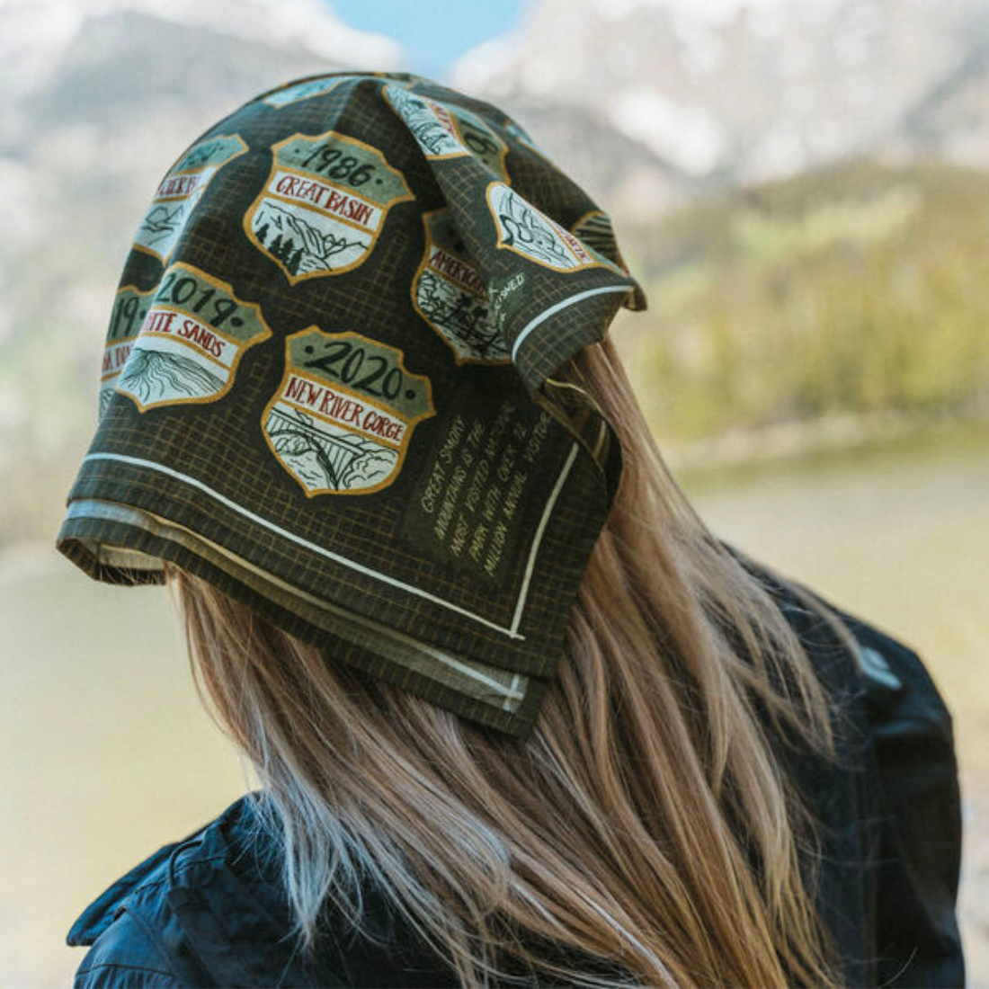 Person wearing a green handker national parks bandana  on head  outdoors
