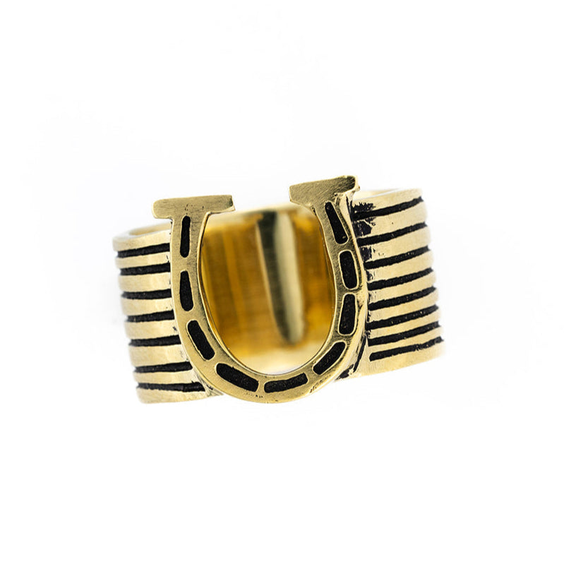 Gold ring with raised horseshoe motif and black enamel detailing