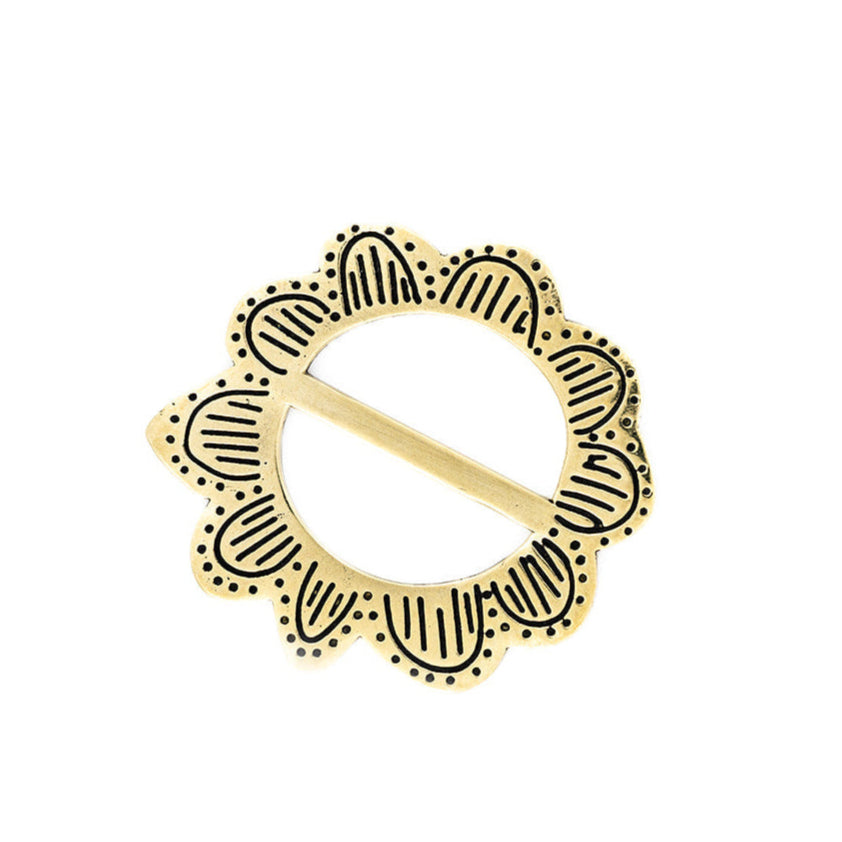 Circular gold-and-black scalloped decorative medallion with a diagonal gold bar across the center
