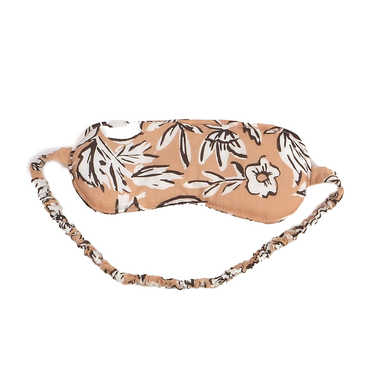 Peach sleep mask with white and dark-brown floral print and ruched elastic strap.